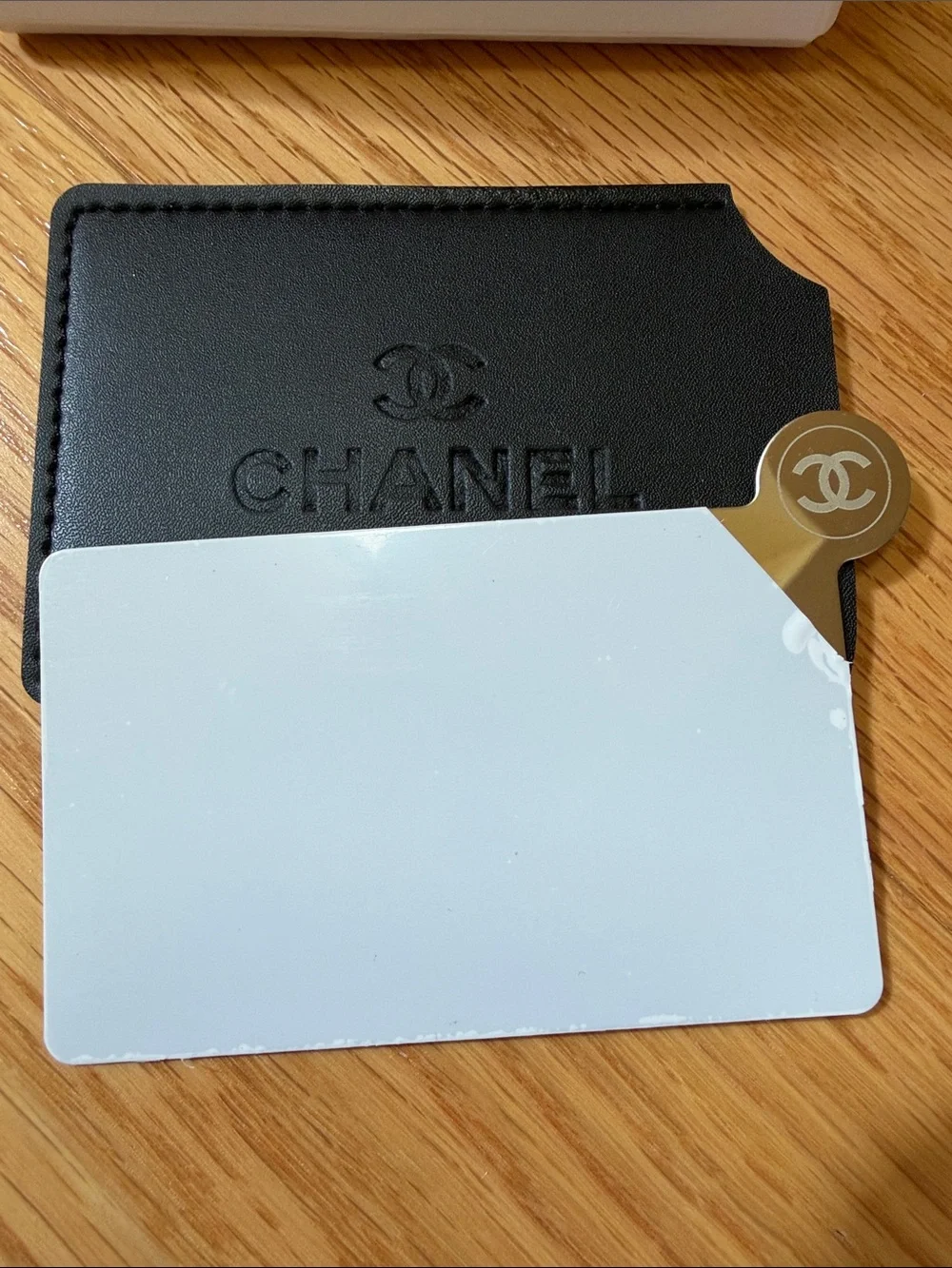 Chanel black card case with mirror.